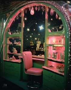 a pink chair sitting in front of a window filled with lots of toys and decorations