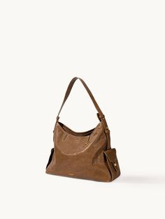 The Small Yore Hobo Bag Timeless Brown Shoulder Bag With Handle Drop, Timeless Brown Hobo Bag With Top Handle, Timeless Brown Hobo Shoulder Bag, Daily Leather-lined Satchel Hobo Bag, Leather Lined Satchel Hobo Bag, Cognac Soft Leather Shoulder Bag For Everyday Luxury, Timeless Hobo Bag For Everyday Use, Daily Brown Textured Leather Shoulder Bag, Everyday Brown Textured Leather Bag