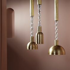 three brass colored lights hanging from a ceiling