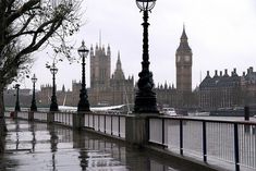 the big ben clock tower towering over the city of london on a rainy day in england