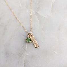 "Dainty mama necklace featuring the birthstone of your choice. Charm and chain made of 14k gold fill. Charm measures just under 3/4\" tall (perfectly tiny and minimal). Includes one birthstone of your choice. Additional birthstones can be added through this link https://www.etsy.com/listing/638829821/add-a-birthstone-gold-or-silver-channel?click_key=1985af54f9f9503a41c6625065a512550a9c5c4b%3A638829821&click_sum=099aa037&ref=shop_home_active_2&crt=1&sts=1 What is \"14k Gold Fill\" ?   Gold filled components contain 100+ times more real gold than gold plated components and are very durable and tarnish resistant. Gold filled jewelry is a beautiful, affordable alternative to solid gold, and can be worn by people with sensitive skin. Hand stamping is a lot like handwritten. Each letter will var Lingot D'or, Personalized Cross Necklace, Skin Hand, Mama Necklace, Birthstone Gifts, Gold Bar, Gold Filled Jewelry, Gifts For New Moms, Sterling Silver Charm