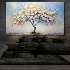 a living room with a large painting on the wall and couches in front of it