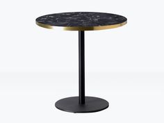 a round table with a black marble top and gold trimmings on the base