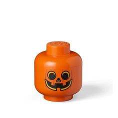 an orange lego brick with a pumpkin face on it