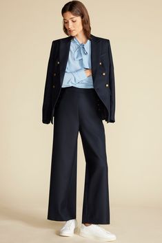 The Sailor Wide Leg Trousers are the epitome of low-key cool. Sitting high on the waist, they're fitted with button accents along the angled seams and a playful nod to traditional mariner style. DESIGN- Classic fit. Choose your usual size.- A wide-leg trouser, fitted at the waist with buttons placed along the front seams.- Metal buttons- Rise: 12 1/2", Inseam: 28"FABRIC & CARE- 50% RWS Wool, 50% polyester- 100% recycled polyester lining- Ethically made in China.- Dry clean only.SUSTAINABILITY- This product is made of material certified by the Responsible Wool Standard (RWS), recycled materials, and other controlled sources.- The Responsible Wool Standard (RWS) aims to improve the welfare of sheep and the land they graze on. RWS farmers and ranchers are evaluated against animal welfare, lan Chic Navy Wide Leg Workwear Pants, Chic Navy Wide Leg Pants For Work, Blue Wide Leg Pants For Fall Workwear, Elegant Navy Bottoms For Fall, Elegant Blue Wide Leg Pants For Fall, Spring Formal Navy Pants, Sweater Blazer, Jumpsuit Skirt, Top Sales