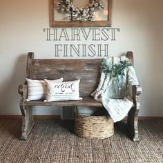 a wooden bench sitting in front of a wall with the words harvestfest finish on it