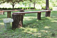 two wooden benches sitting next to each other in the grass