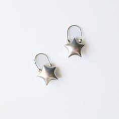 The Star Earrings 1 inch Length 1 inch width An original 67 design. The Star Earrings, hand designed and created by us. We have spent hours perfecting the shape. An ode to the origami puff star. Easy and lightweight to wear. 100% Sterling silver Any flaws or minor inconsistencies are characteristics of this handmade item. We have done a wear test to ensure our products last.