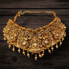 About the Jewellery This Asp Fashion Jewellery Nagas Choker Set is a beautiful, antique-style set. It features an eye-catching Godess Laxmi motif in the center of the choker, plus matching earrings. Add a classic, sophisticated look to any ensemble with this exquisite jewellery set. Details & Specifications: Materials used: Silver,Brass Polish-24 k gold  Finish -Nagas Length -14 Inches  Width -3 Inches  Weight -148 Gms Earrings-yes Earrings Length - 3 Inches Earrings Weight -45 Gms Type -push ty Ornate Bridal Necklace With Intricate Design, Antique Gold Bridal Necklace For Ceremonial Occasion, Elegant Engraved Temple Necklace For Rituals, Traditional Wedding Necklace With Historical Design, Vintage Gold Temple Necklace With Intricate Design, Antique Gold Temple Necklace With Intricate Design, Antique Gold Bridal Necklace With Tilla, Ornate Temple Necklace With Intricate Design, Vintage Gold Bridal Necklace With Intricate Design