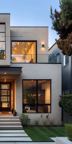 a modern house with steps leading to the front door