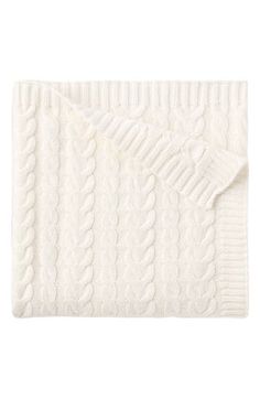 a white blanket with cable knits on top and an open pocket in the middle