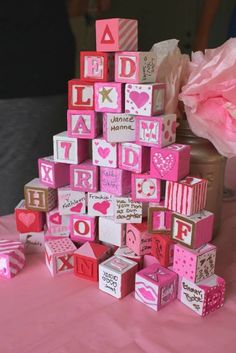 pink and white blocks are stacked on top of each other in the shape of a tree