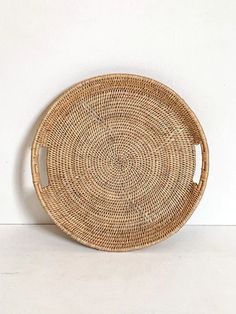 a wicker plate sitting on top of a white table