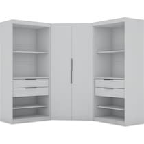 an open white closet with drawers and shelves