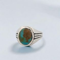 Introducing the Weeping Mary ring, a vintage-inspired piece crafted from sterling silver. This artisan ring boasts an intricate, vintage-style cast design, giving it a touch of timeless elegance. At its heart lies a mesmerizing green-toned Kingman turquoise cabochon, known for its unique and captivating beauty. Sized at 11, this ring ensures a comfortable fit while making a bold and stylish statement. Features Handcrafted sterling silver: Beautifully designed with a vintage touch. Green Kingman Antique Turquoise Sterling Silver Ring, Handmade Classic Turquoise Sterling Silver Ring, Handmade Classic Sterling Silver Turquoise Ring, Heirloom Style Turquoise Sterling Silver Ring, Antique Silver Turquoise Ring With Patina, Classic Adjustable Turquoise Ring In Sterling Silver, Vintage Handmade Oval Turquoise Ring, Vintage Sterling Silver Open Ring, Vintage Blue Turquoise Ring Engraved