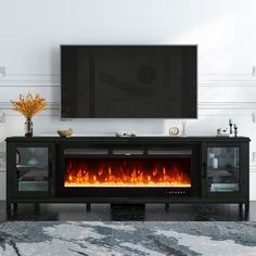 an entertainment center with a fireplace in the middle and a flat screen tv above it