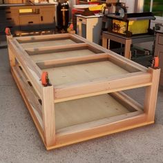 a wooden shelf sitting in the middle of a room filled with cabinets and other items