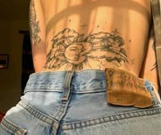 the back of a woman's stomach with tattoos on it