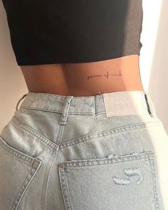 the back of a woman's stomach showing her lower body and thighs with writing on it