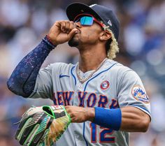 a baseball player with sunglasses on his face and holding a catchers mitt in one hand