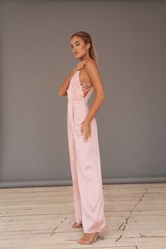 Backless Jumpsuits And Rompers For Spring Formal, Backless Formal Jumpsuits And Rompers For Spring, Backless Formal Jumpsuit For Spring, Formal Backless Jumpsuit For Spring, Elegant Pink Stretch Jumpsuits And Rompers, Elegant Stretch Pantsuit For Parties, Elegant Flared Bottoms For Wedding, Spring Fitted Floor-length Jumpsuits And Rompers, Spring Satin Fitted Jumpsuits And Rompers