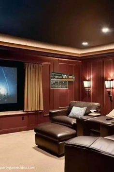 a home theater with leather chairs and a flat screen tv on the wall in front of it