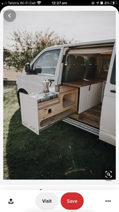 a white van with its doors open on the grass