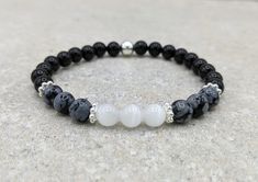 "This stretch bracelet is made with your choice of either 6mm or 8mm Black Obsidian, Snowflake Obsidian and Selenite gemstone beads.  It is accented with a round silver plate bead and spacer beads. These gemstones are known for providing protection against and removal of negative energy.   It is perfect for empaths and anyone dealing with negativity or anxiety.  Empaths are highly sensitive people who can easily feel the energy of others.  Black Obsidian is considered to be one of the most effec Empath Protection, Highly Sensitive People, Sensitive People, Snowflake Obsidian, Protection Bracelet, Black Obsidian, Empath, Gemstone Bracelets, Bracelet Sizes