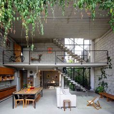 an open living area with stairs and tables