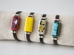 Colorful women's leather bracelet with rectangular ceramic and silver brass beads. Dark brown flat leather and ceramic bracelet in 4 colors with an original speckled effect (turquoise green, burgundy, yellow and beige). Cute bracelet with bright and vivid colors. Unique handmade contemporary boho style summer jewelry. Ideal gift for her, gift for mom, sister, daughter, friend... Important: Always measure your wrist circumference to ensure you have the correct size. Bracelet suitable for wrists from 14 to 16 cm. Outline. (5.5 to 6.3 inches) Care: It can get wet. It is recommended to hydrate the leather with grease or cream if necessary. ELABORATION Each ceramic piece is carefully modeled with white clay and hand painted with special ceramic glazes. Two firings of up to 1200 º C are necessar Everyday Leather Bracelet Jewelry, Adjustable Everyday Jewelry Bracelet, Modern Handmade Jewelry For Everyday Use, Handmade Rectangular Bracelets, Minimalist Rectangular Leather Jewelry, Handmade Adjustable Rectangular Leather Bracelet, Modern Adjustable Rectangular Jewelry, Bohemian Leather Jewelry For Everyday, Bohemian Rectangular Jewelry For Everyday