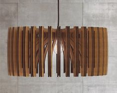 a wooden light fixture hanging from a ceiling in a room with tile walls and flooring