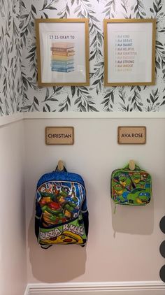 two backpacks are hanging on the wall in front of some pictures and other items