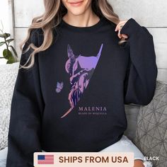 a woman wearing a black sweatshirt with an image of the statue of liberty on it