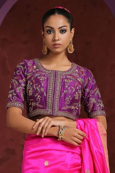 Purple blouse in raw silk base with floral pattern zardozi hand embroidery.
Component: 1
Pattern: Hand Embroidered
Type Of Work: Zardozi
Neckline: Round
Sleeve Type: Half
Fabric: Raw Silk
Color: Purple
Other Details: 
Floral jaal patterns
Note: Saree worn by the model is not for sale
Occasion: Wedding - Aza Fashions Diwali Semi-stitched Resham Embroidered Top, Semi-stitched Blouse With Intricate Embroidery For Navratri, Semi-stitched Tissue Silk Blouse For Navratri, Designer Eid Blouse In Chinon, Wedding Blouse With Multicolor Embroidery And Cutdana, Designer Chinon Blouse For Eid, Traditional Embroidered Top With Traditional Drape For Wedding, Chinon Saree Blouse For Eid, Traditional Embroidered Top With Drape For Wedding