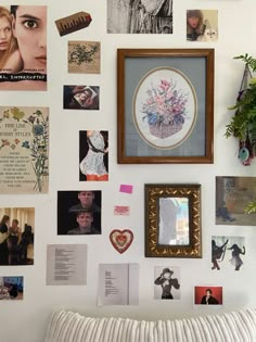 a wall covered in pictures and photos with a pillow on top of the couch next to it