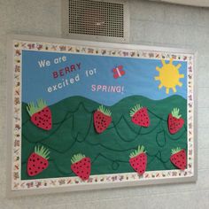 a bulletin board with strawberries on it and the words we are berry excited for spring