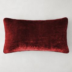 a red velvet pillow on a white wall