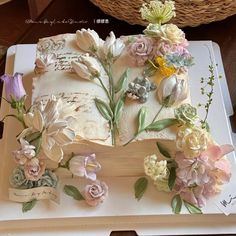 a cake decorated with flowers on top of a table