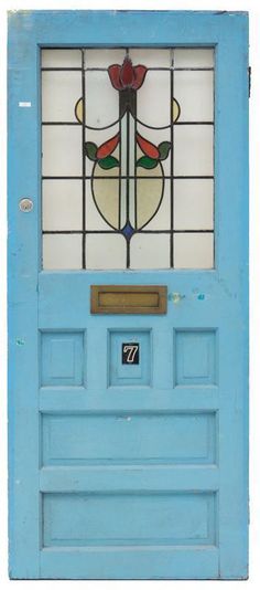 a blue door with a stained glass window above it