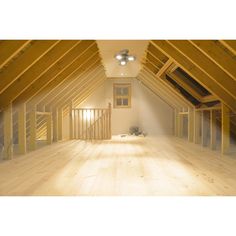 an attic with wooden flooring and exposed rafters on the ceiling is shown in this image