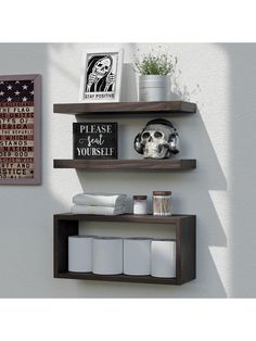 two wooden shelves with pictures and other items on them, one shelf is holding toilet paper