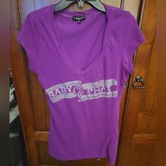 **These Are Rare Y2k Tees You Will Not Find Anywhere Else** Description: Purple Baby Phat Tee Short Sleeve Silver Glitter With Rhinestones Baby Phat Logo With Signature Cat On Front Size Medium Brand New Super Cute Hard To Find Top! Any Questions Feel Free To Message Me Logo With Signature, Y2k Tees, Rhinestone Tees, Purple Baby, Baby Phat, Fancy Dresses, Silver Glitter, Vintage Y2k, Super Cute