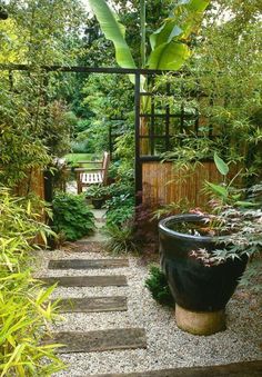 a garden with steps leading up to a bench