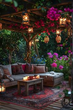 an outdoor living area with lots of flowers and lights