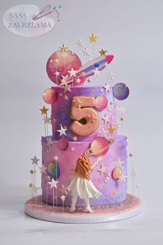 a colorful cake decorated with stars and planets