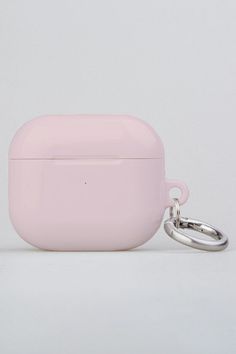 a pink case with a keychain attached to it on a white table top