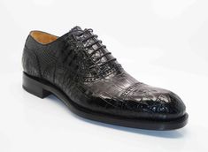 Style: 5817-1233A-Black Exclusively for C & E, this Completely Handmade, Hand Burnished Genuine Alligator lace-up oxford from the Ugo Vasare collection features Goodyear Welted construction, soft Calfskin lining, a Cap Toe, Decorative Perforations with Pinking Detail, a stitched welt and a full Leather sole! Please note: Some sizes are on Back Order. Classic Crocodile Pattern Oxfords For Office, Classic Fitted Oxfords With Crocodile Pattern, Formal Fitted Oxfords With Crocodile Pattern, Elegant Formal Oxfords With Crocodile Pattern, Luxury Fitted Oxfords For Galas, Luxury Fitted Oxfords For Semi-formal Occasions, Classic Black Oxfords With Crocodile Pattern, Cordovan Shoes, Shoe Horn