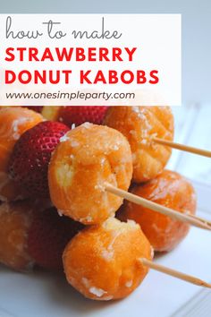 strawberry donut kabobs on a white plate with strawberries