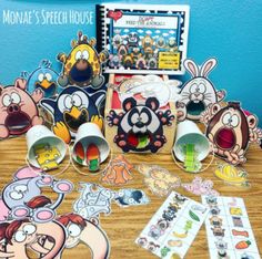 an assortment of speech therapy activities with cartoon characters on the table in front of them