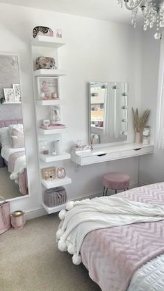 a bedroom with a bed, dresser and mirror next to a chandelier hanging from the ceiling